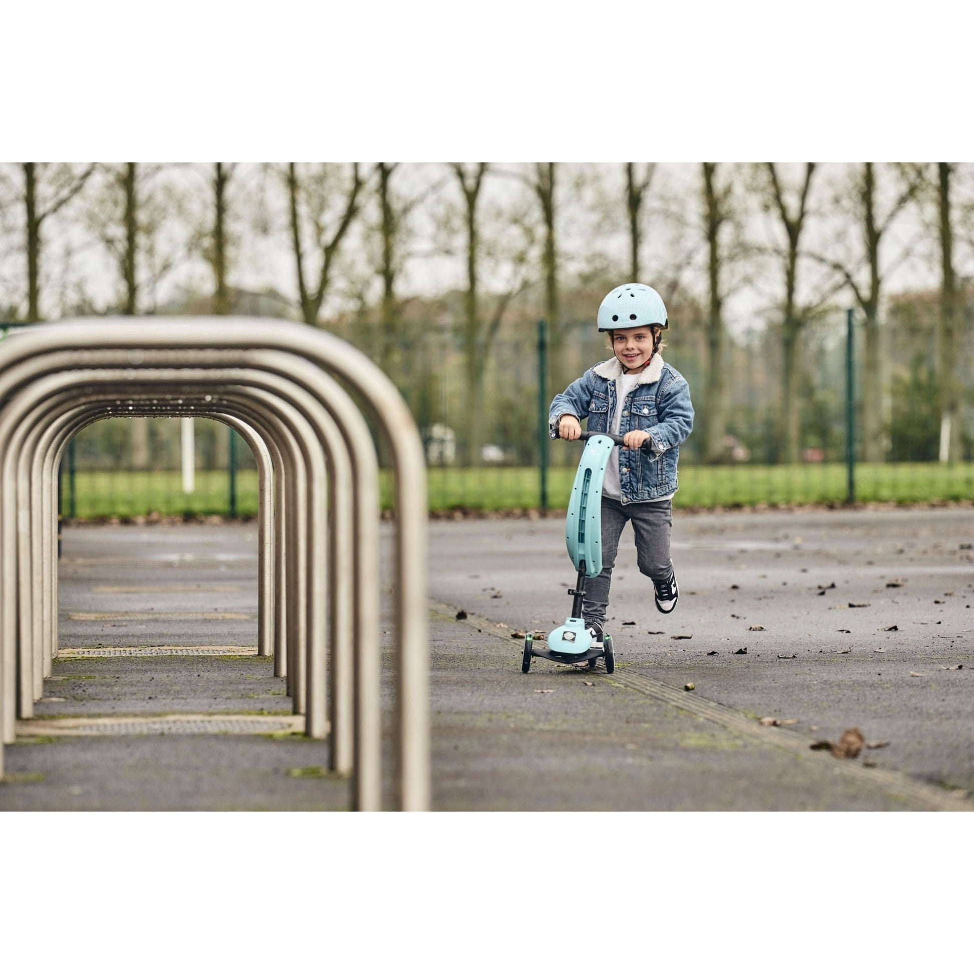 child riding Ride-Ezy Kick & Go Scooter - Kingfisher on tarmac