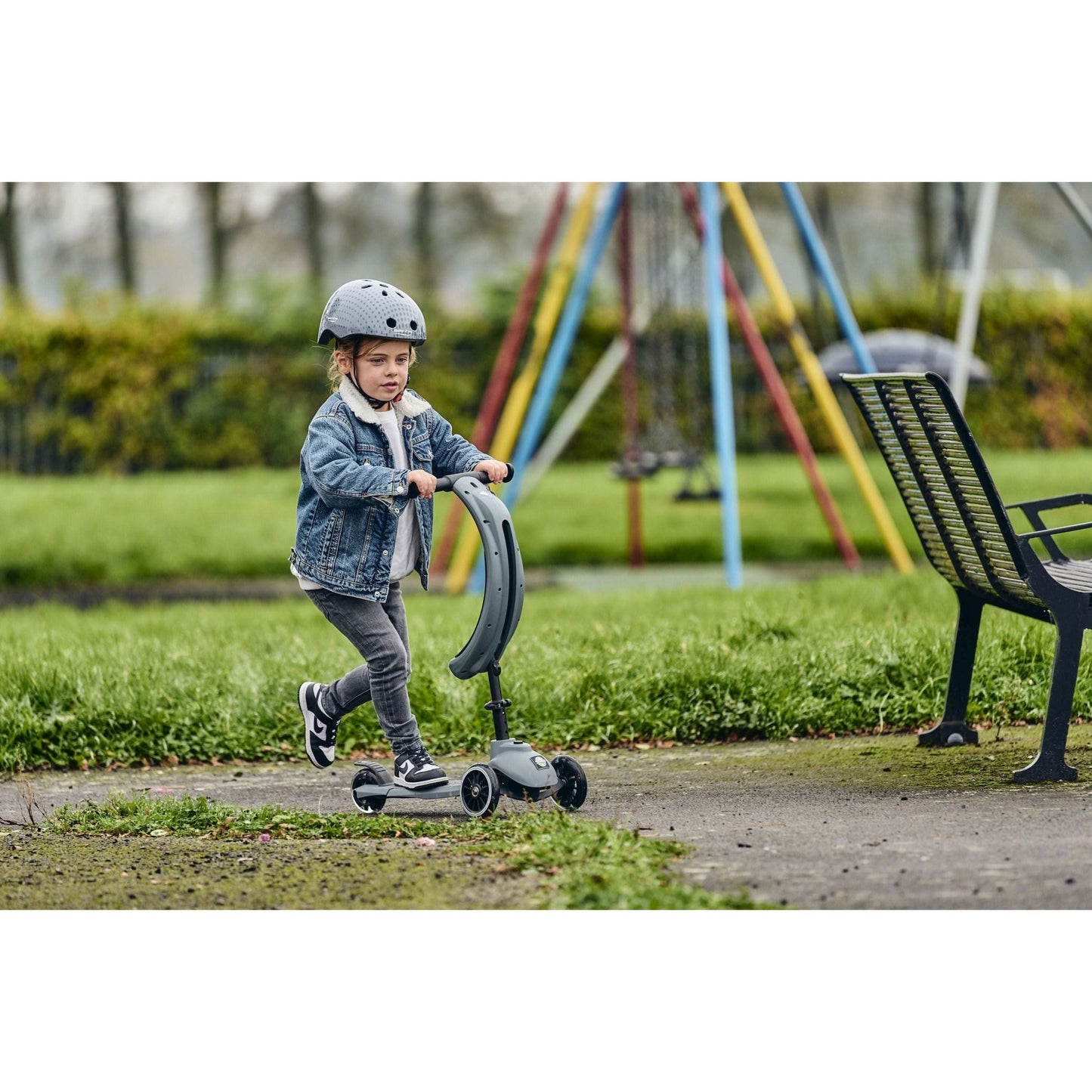 child riding Ride-Ezy Kick & Go Scooter - Thunder Cloud in park