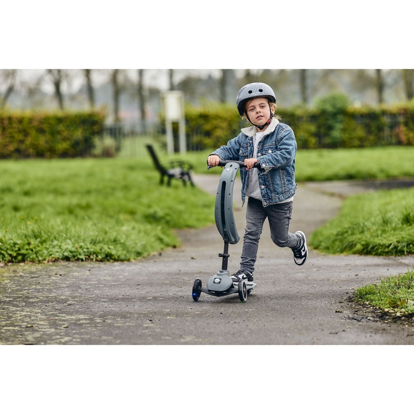 child riding Ride-Ezy Kick & Go Scooter - Thunder Cloud in park