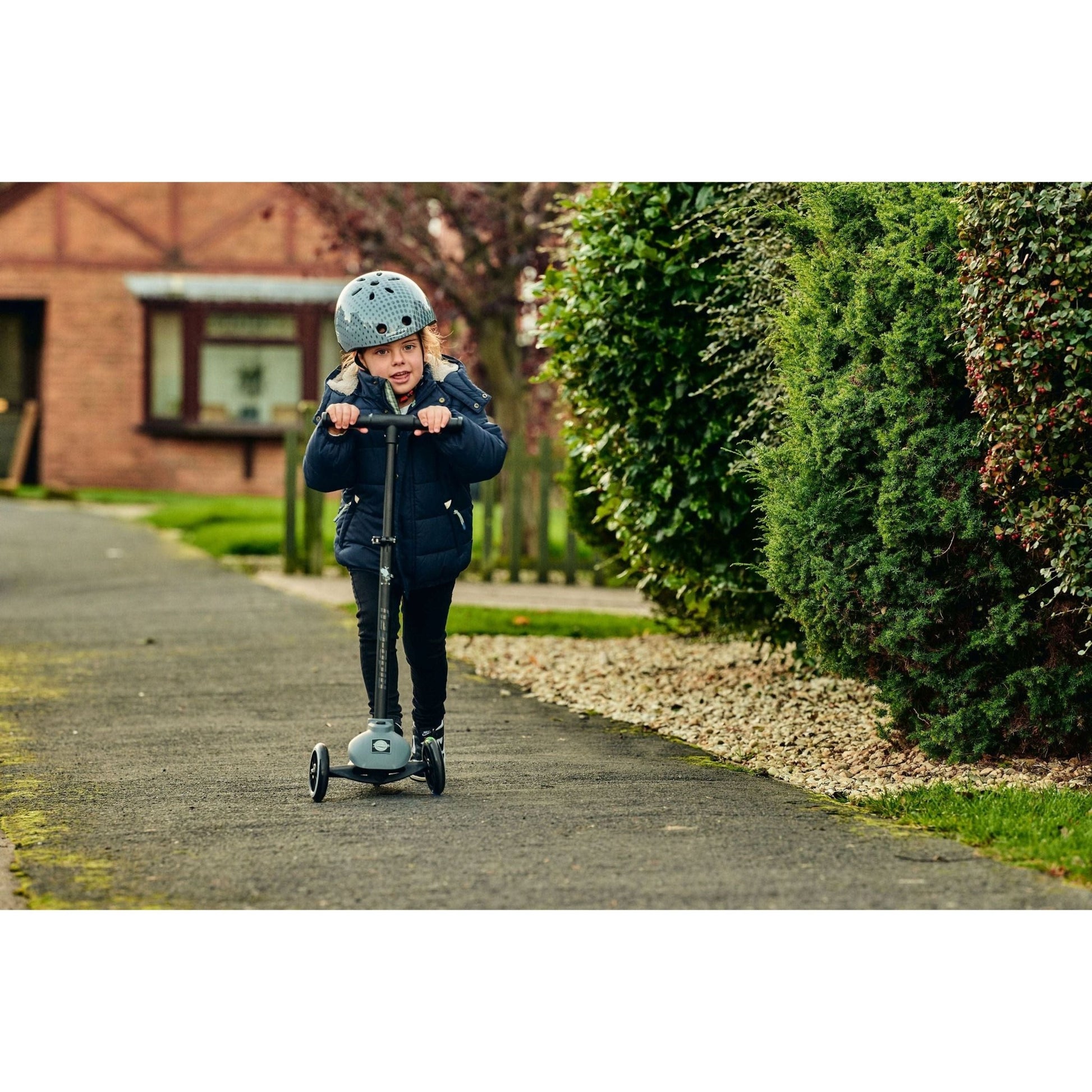 girl riding Ride-Ezy Kick & Go Scooter - Thunder Cloud on pavement