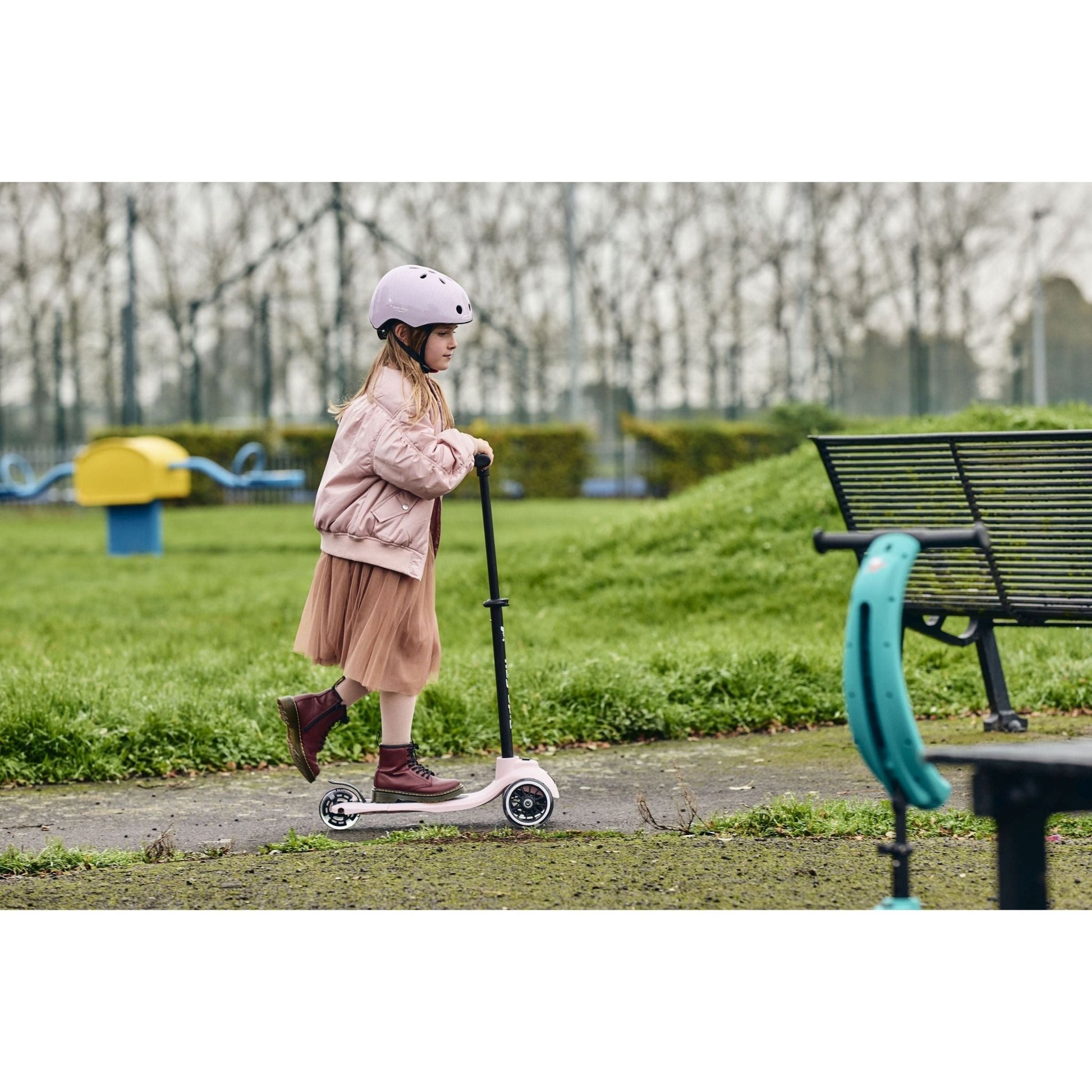 girl riding Ride-Ezy Kick Scooter - Blossom near bench in park