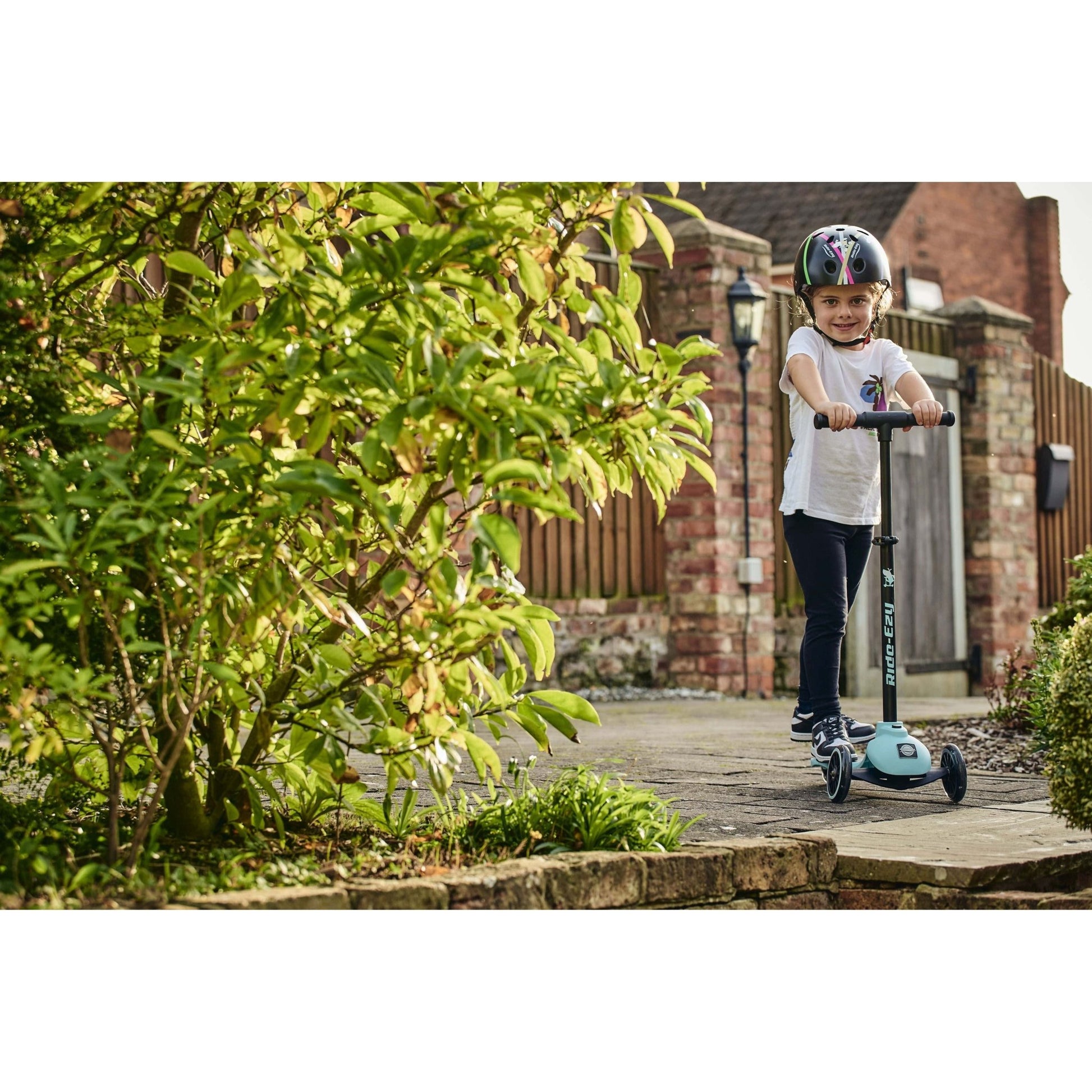 child riding Ride-Ezy Kick Scooter - Kingfisher near steps