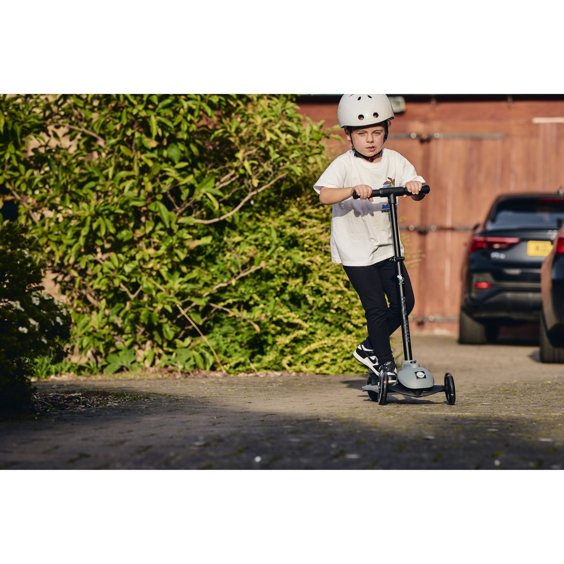 close up of child riidng Ride-Ezy Kick Scooter - Thunder Clouds on pathway