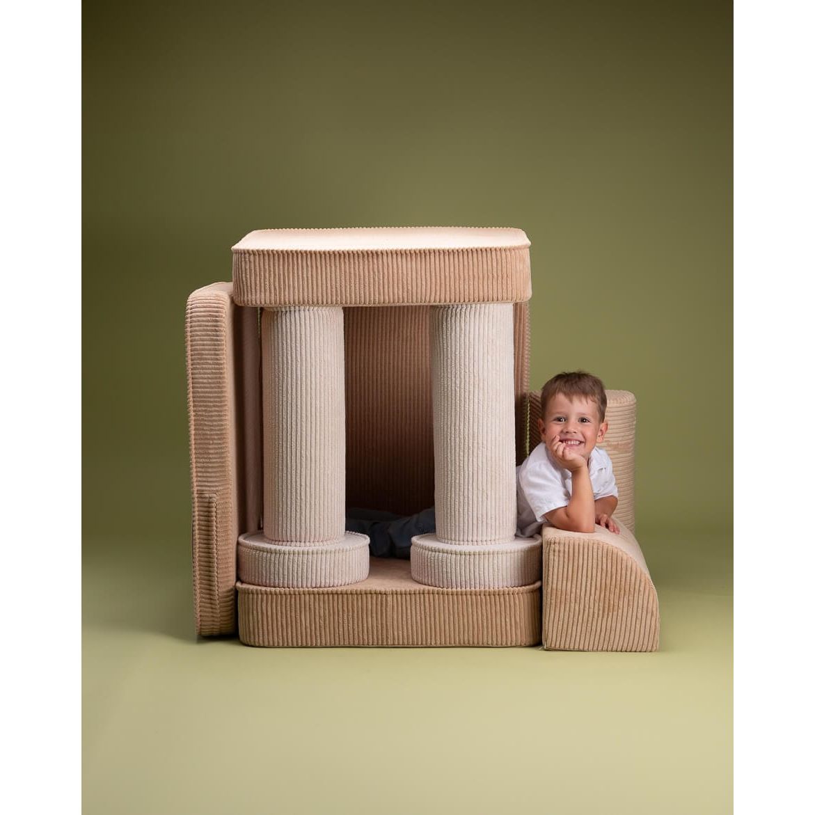 boy sitting on Wigiwama Brown Sugar Settee with pieces stacked
