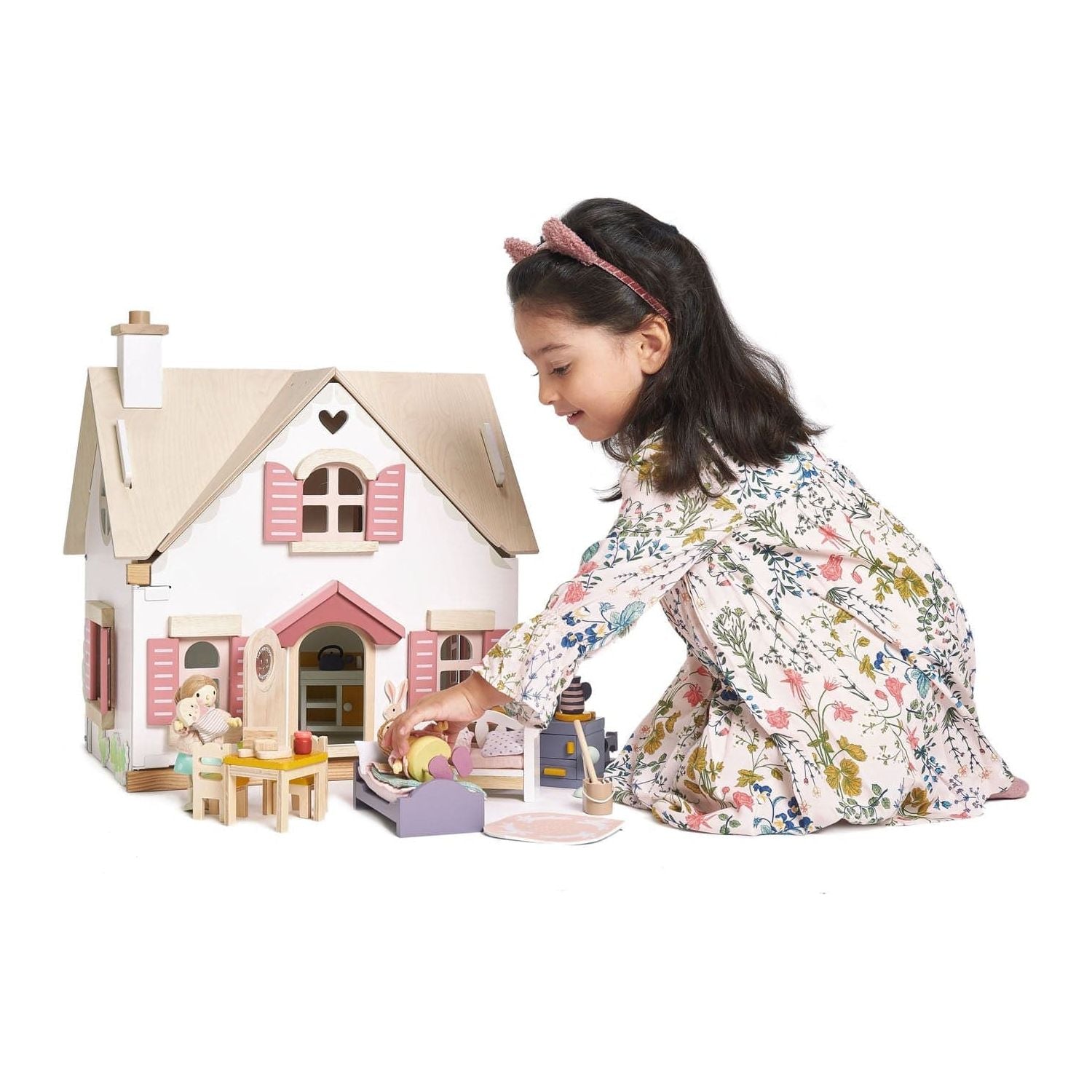 girl playing with Tender Leaf Cottontail Cottage + Furniture Wooden Doll House