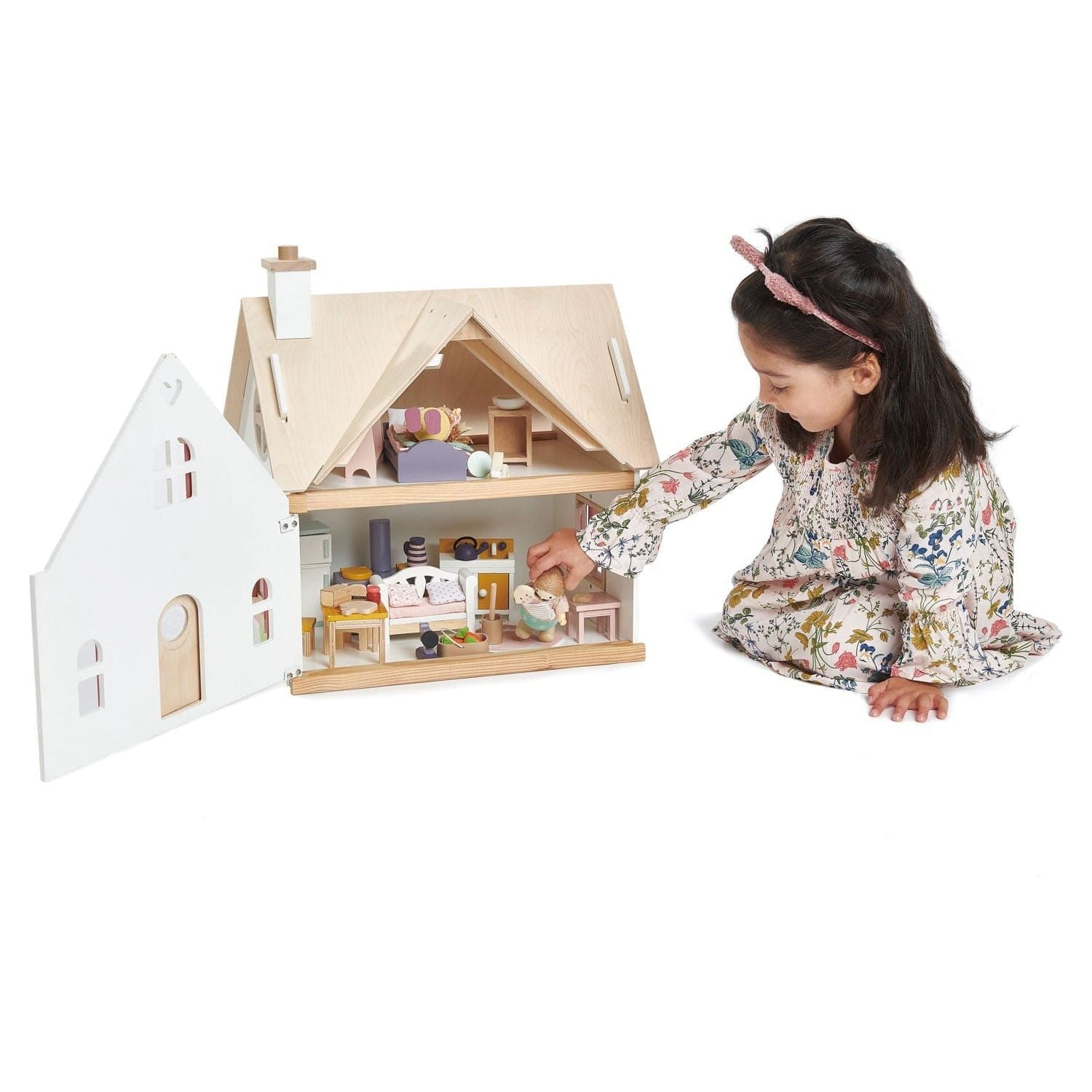 girl playing with opened Tender Leaf Cottontail Cottage + Furniture Wooden Doll House