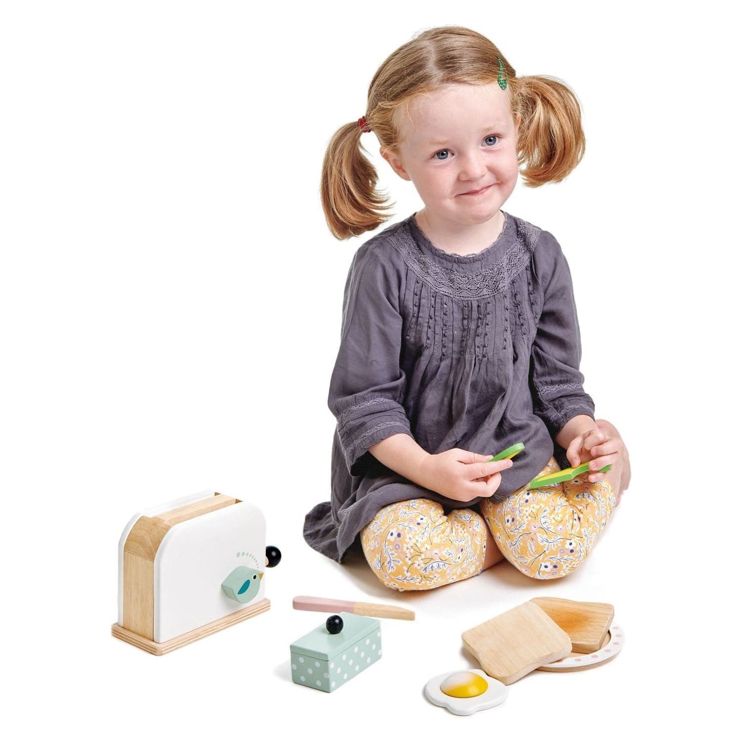 girl playing with Tender Leaf Breakfast Wooden Toaster Set