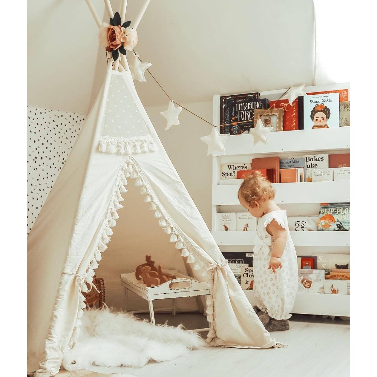 little girl in playroom in front of MINICAMP Boho Kids Teepee With Tassels