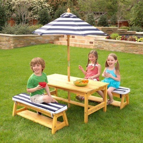 three children sitting at Outdoor Table & Bench Set with Cushions & Umbrella - Navy & White Stripes