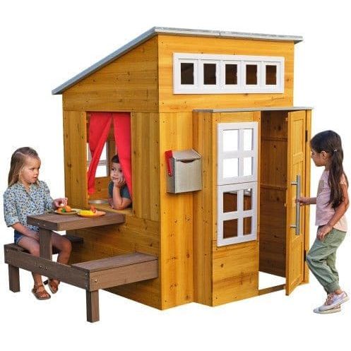 KidKraft Modern Outdoor Playhouse with child sitting at outdoor table