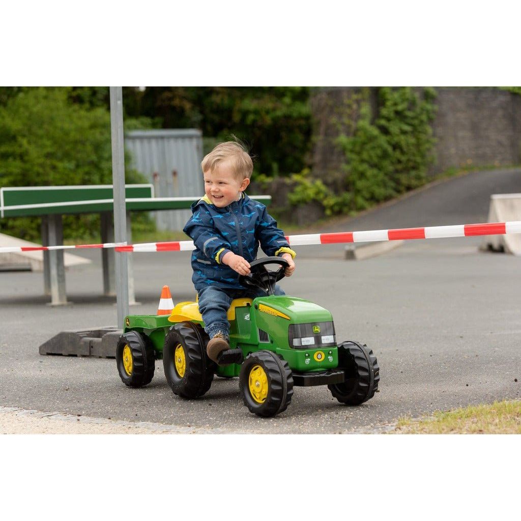 boy sitting on Rolly Toys John Deere Tractor & Trailer