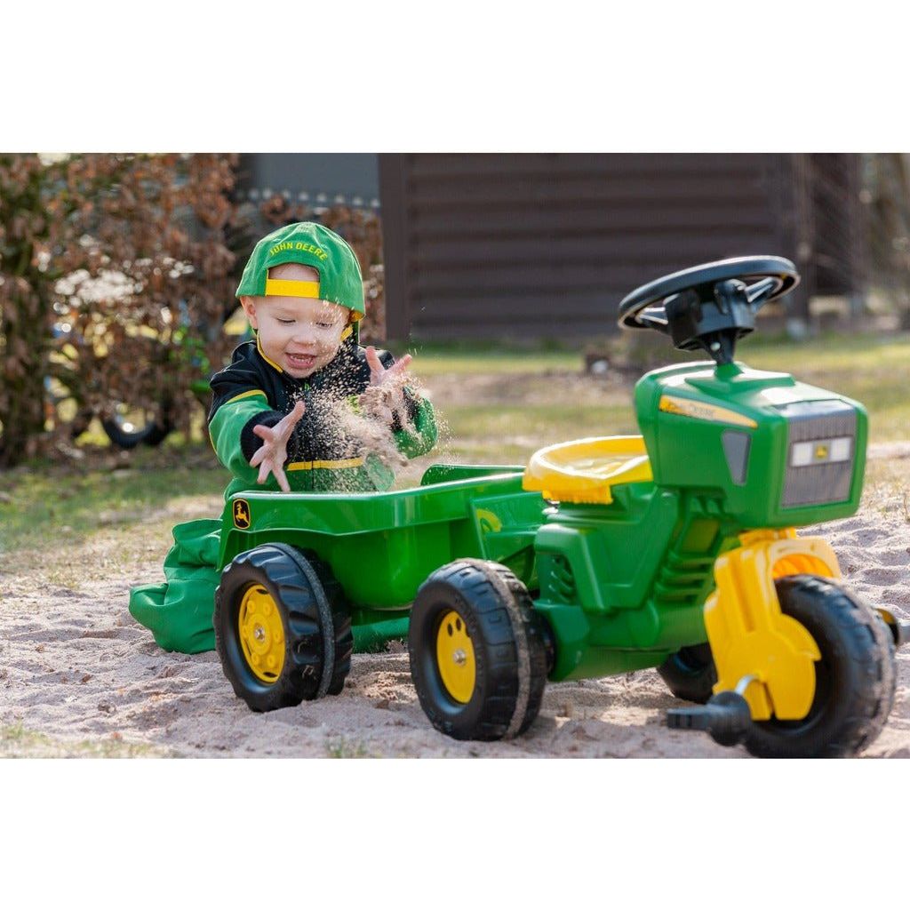 boy throwing sand into trailer of Rolly Toys John Deere Trio Trac with Electronic Steering Wheel & Trailer