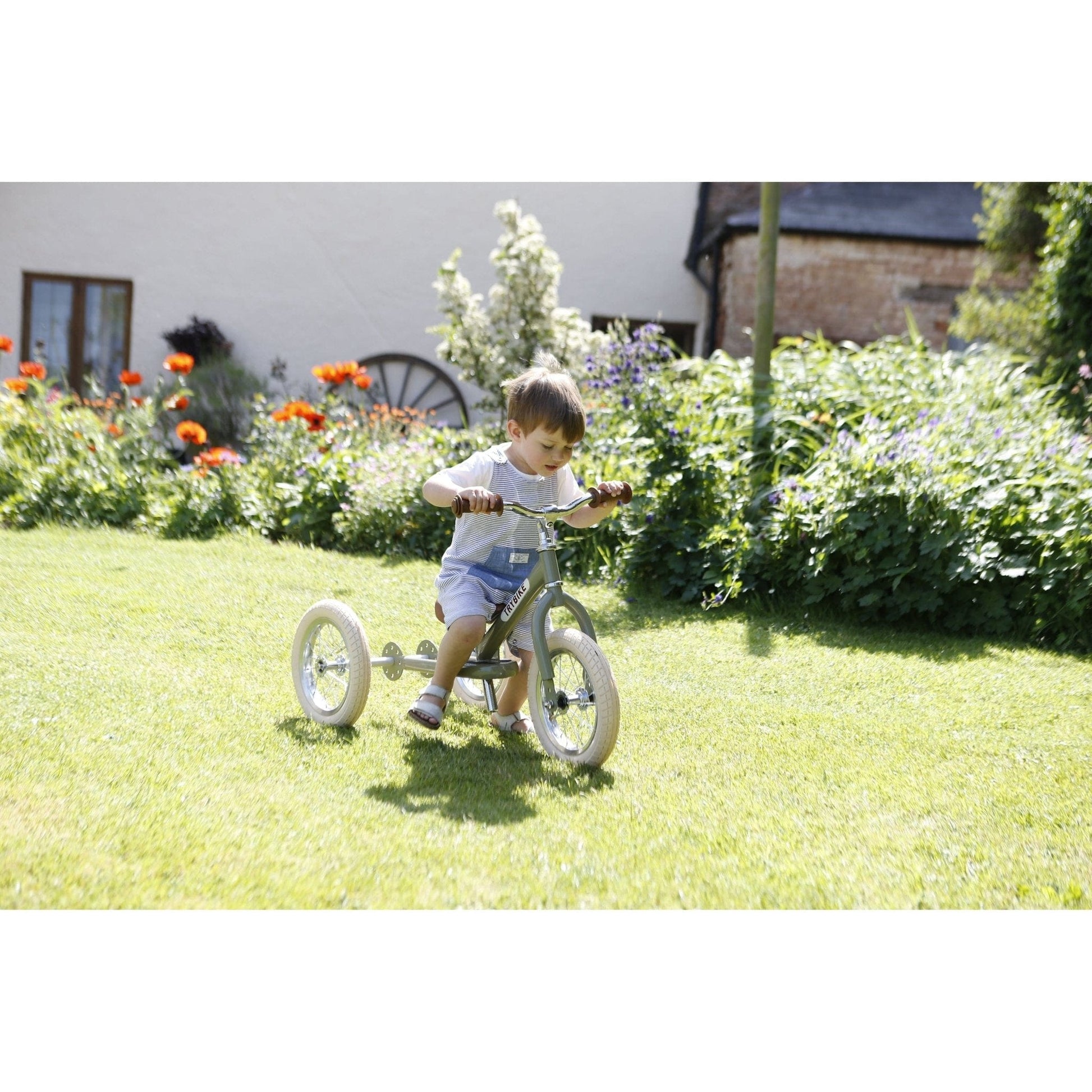 boy riding TryBike - Steel 2 in 1 Balance Trike Bike - Vintage Green in garden