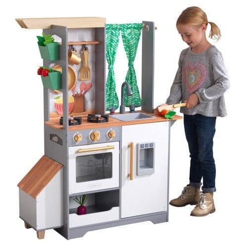 girl chopping vegetables in Kidkraft Terrace Garden Play Kitchen