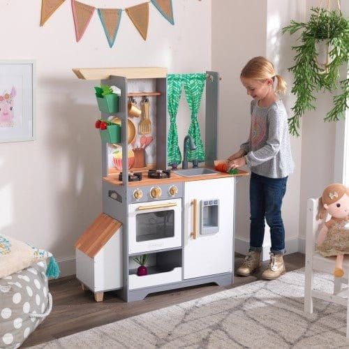 girl playing with Kidkraft Terrace Garden Play Kitchen in playroom