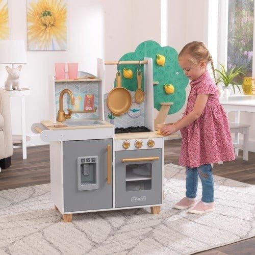 little girl playing with Kidkraft Happy Harvest Play Kitchen