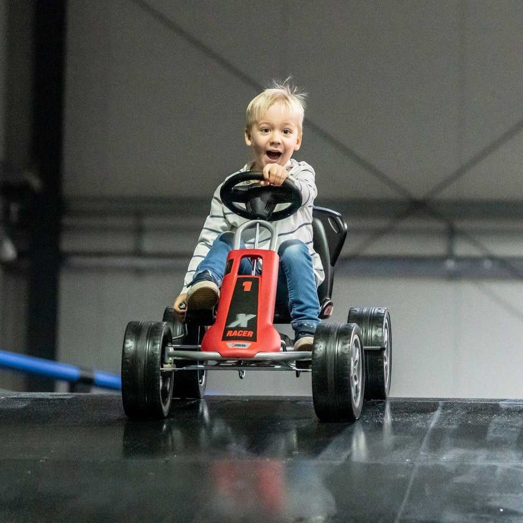 smiling boy on race track in red Ferbedo X-Racer Go Kart