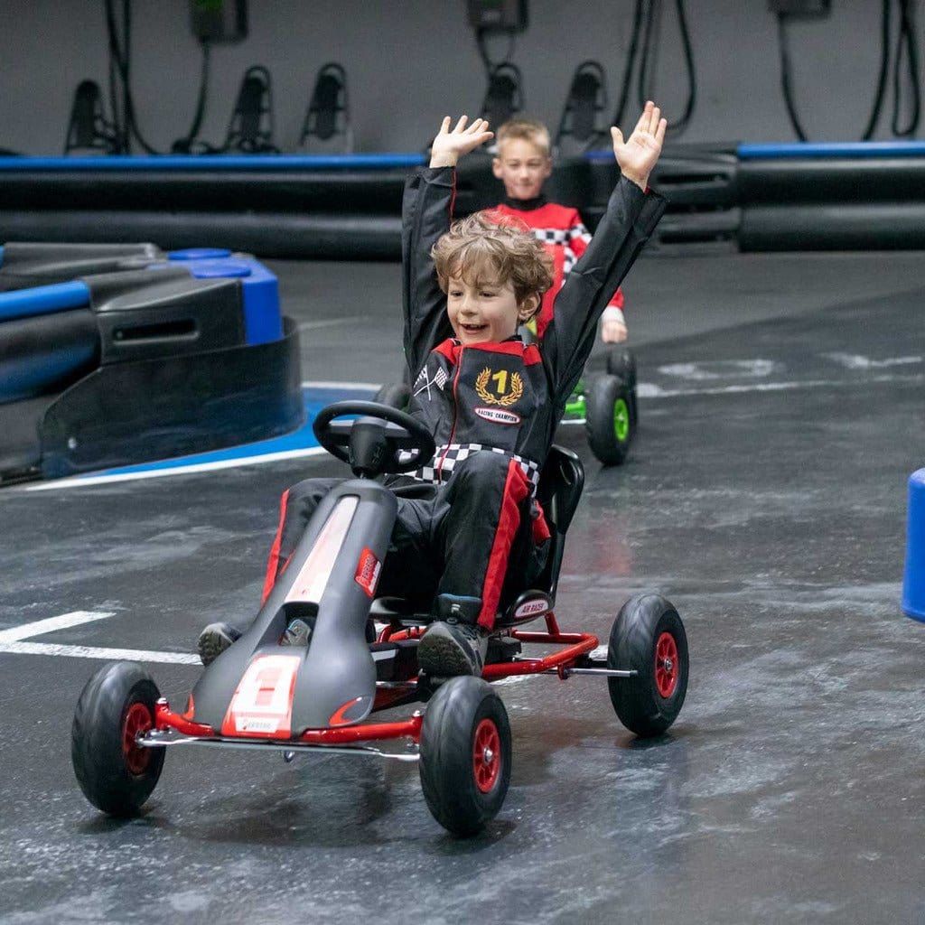 boy with arms in air on racing track driving Ferbedo AR8R Go Kart