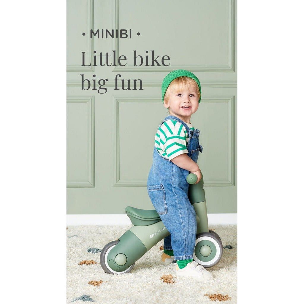 little boy riding Green Kinderkraft Minibi Tricycle