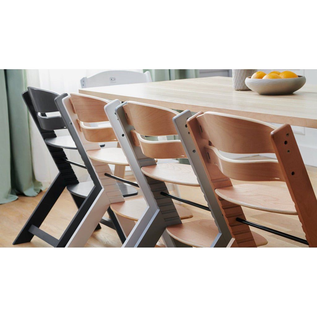 4 Kinderkraft Enock High Chairs next to each other in wood, white and grey