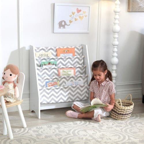 girl sitting reading book in front of KidKraft Sling Bookshelf - Gray & White