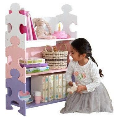 girl in front of Kidkraft Puzzle Bookshelf - Pastel
