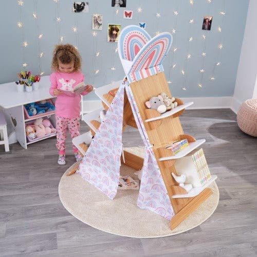 girl standing next to KidKraft Book Nook Tent with Shelves