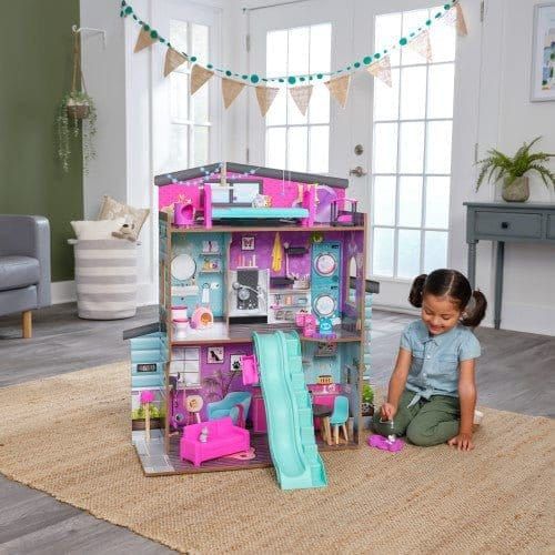 girl kneeling to right of Kidkraft Purrfect Pet Dollhouse