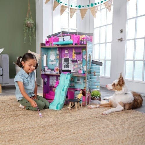 girl playing with Kidkraft Purrfect Pet Dollhouse with dog
