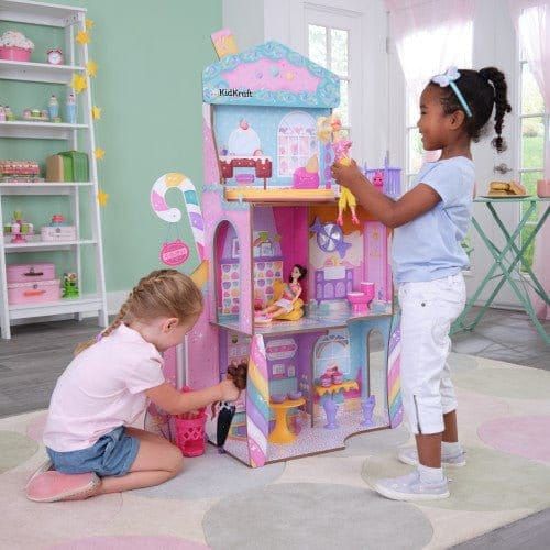 children playing with KidKraft Candy Castle Dollhouse