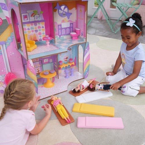 girls playing with dolls in KidKraft Candy Castle Dollhouse