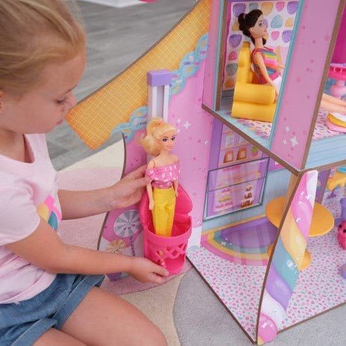 girl with doll in elevator of KidKraft Candy Castle Dollhouse