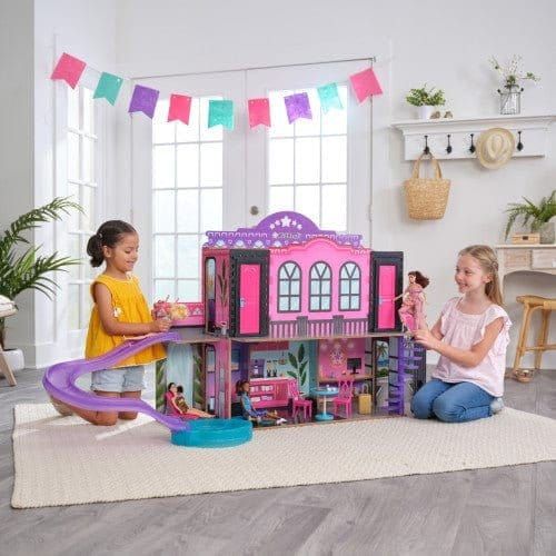 giels playing with KidKraft 2-in-1 Hotel & Waterslide Dollhouse in lounge