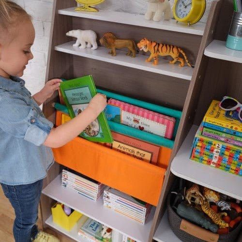girl putting book back on shelf of KidKraft Pocket Storage Bookshelf - Gray Ash