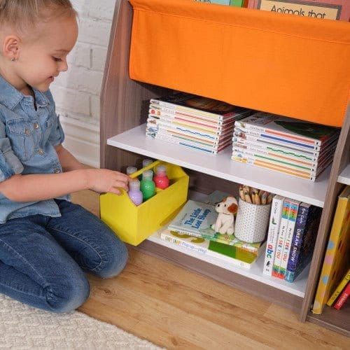 girl putting toys back on KidKraft Pocket Storage Bookshelf - Gray Ash
