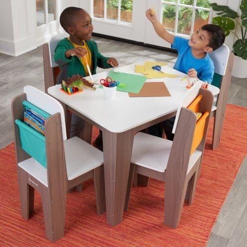 2 boys sitting at KidKraft Pocket Storage Table and 4 Chair Set - Grey Ash