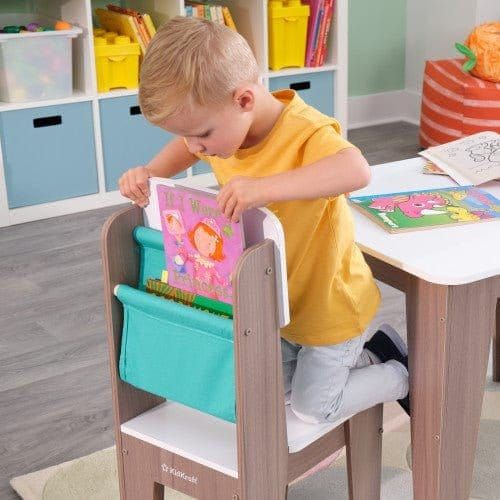 boy reaching into storage container of chair from KidKraft Pocket Storage Table & 2 Chair Set - Gray Ash
