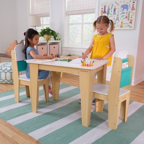 gfirl standing at KidKraft Pocket Storage Table & 2 Chair Set - Natural in playroom