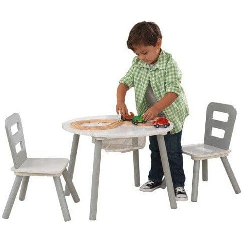 boy playing with toy cars on KidKraft Round Storage Table & 2 Chair Set - Grey & White