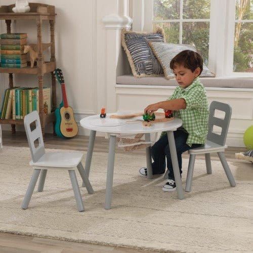 boy sitting at KidKraft Round Storage Table & 2 Chair Set - Grey & White