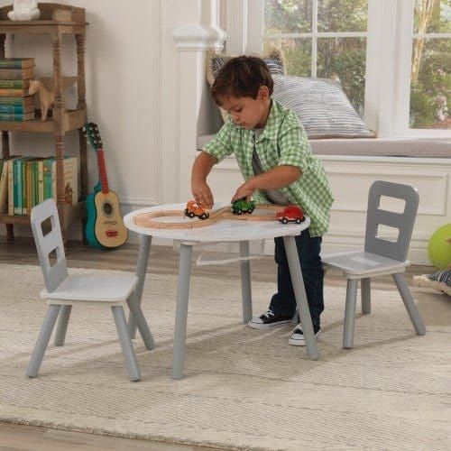 boy playing with yoys at KidKraft Round Storage Table & 2 Chair Set - Grey & White