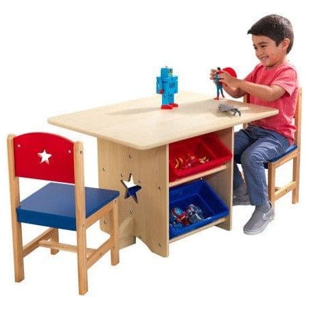 boy sitting at KidKraft Star Table & Chair Set playing with robot toy