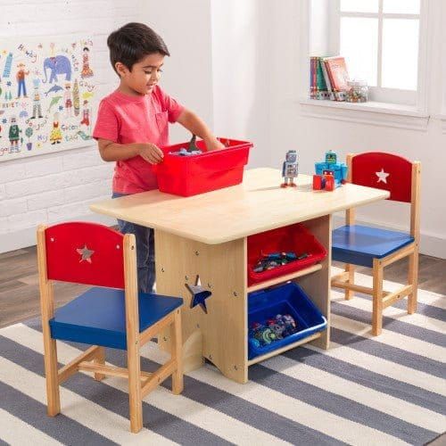 boy getting toy from storage box of KidKraft Star Table & Chair Set