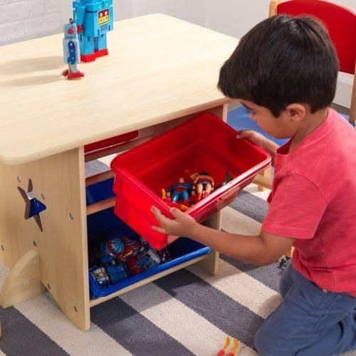 boy putting storage box back on KidKraft Star Table & Chair Set