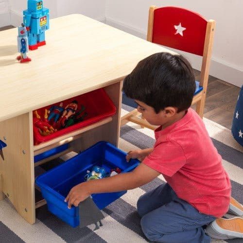 boy getting storage box out of KidKraft Star Table & Chair Set
