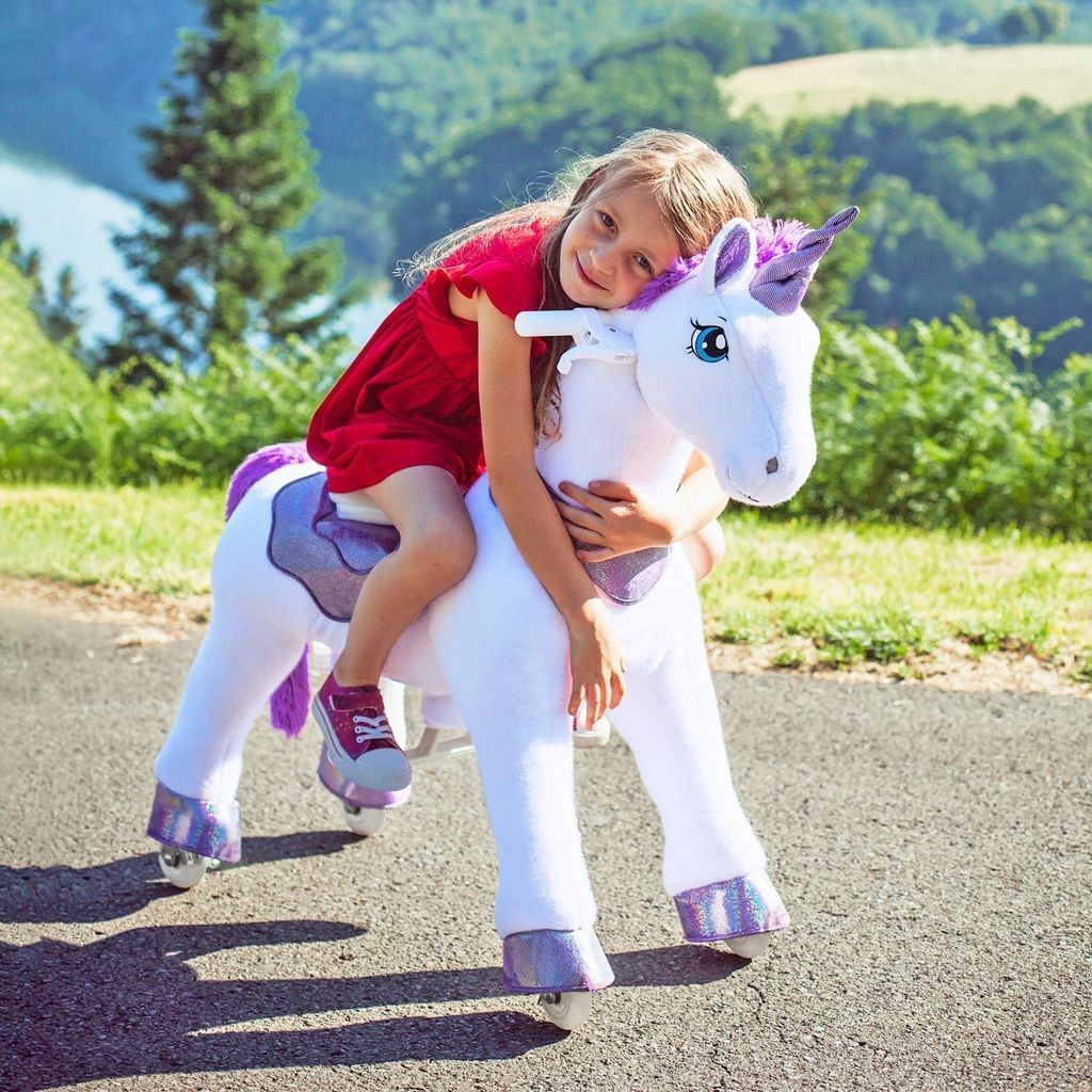 girls cuddling Ponycycle Model E Unicorn Riding Toy Age 3-5