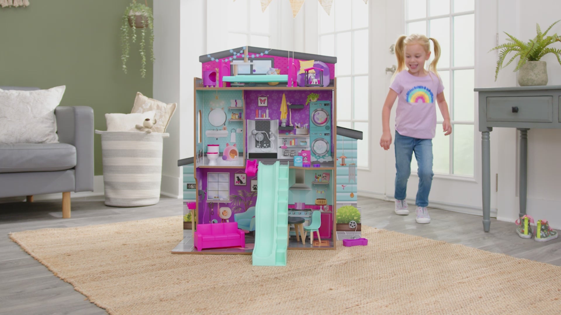 girl in playroom playing with Kidkraft Purrfect Pet Dollhouse