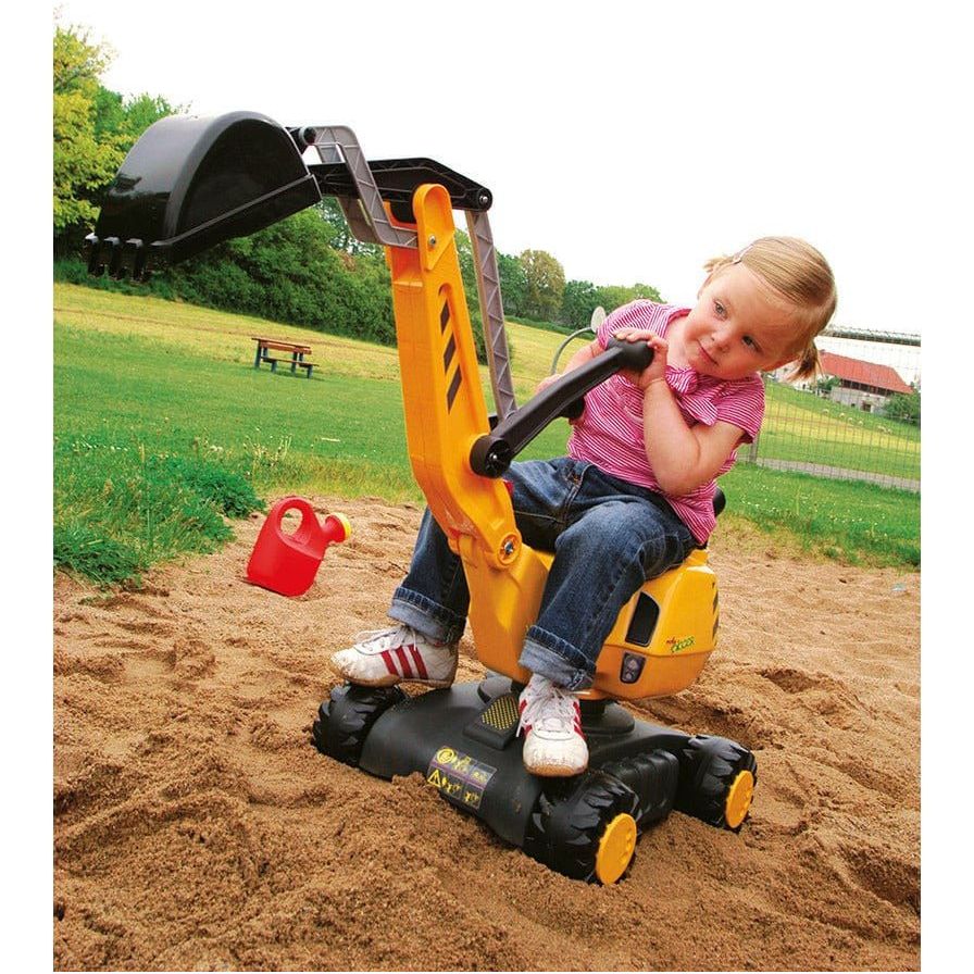 girl riding Rolly Toys Mobile 360 Degree Excavator - Yellow