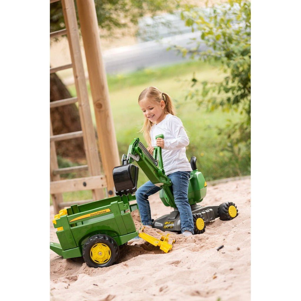 girl sitting on Rolly Toys John Deere Mobile 360 Degree Excavator in sandpit