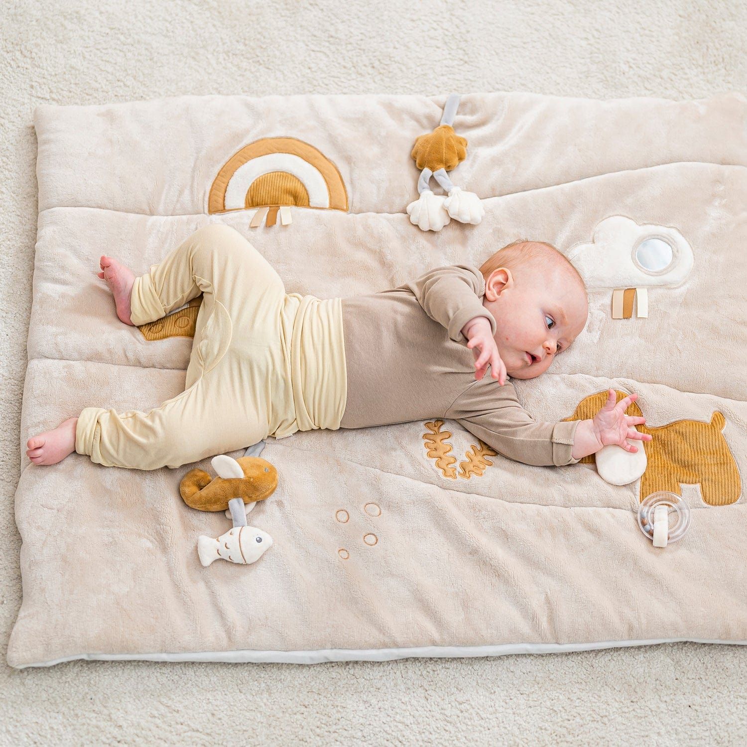 baby lying on Nattou Baby Activity Mat - Charlie The Dog